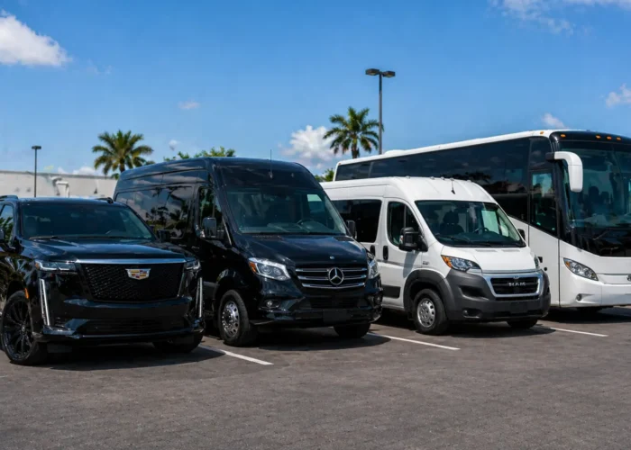 Fleet of group vehicles in Miami: black SUV, Mercedes Sprinter van and touring coach parked together